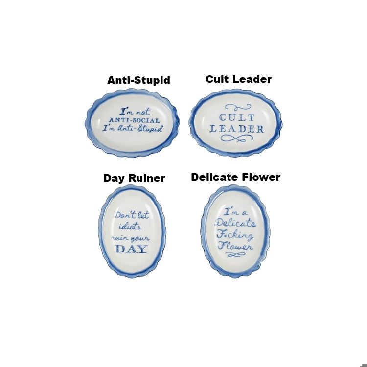 Four white stoneware scalloped dishes with blue trim and witty sayings in blue script.