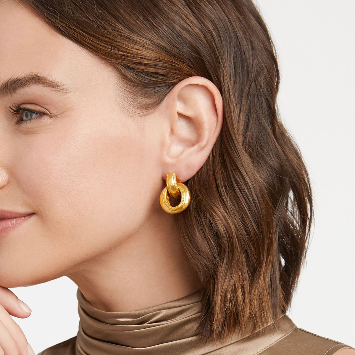 Gold-plated Cannes doorknocker earring with a curved bar silhouette.