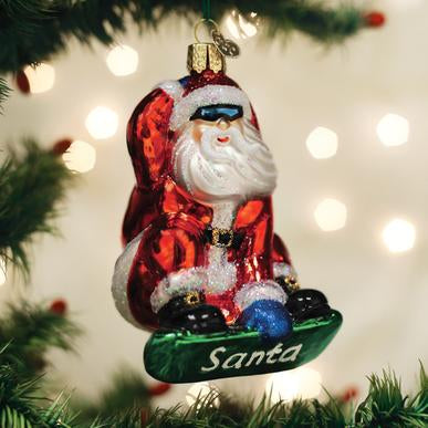 Snowboarding Santa glass ornament wearing sunglasses on a green snowboard with 'Santa' text.
