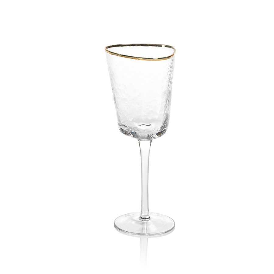 Aperitivo triangular wine glass in clear hammered glass with a gold rim on a long stem.