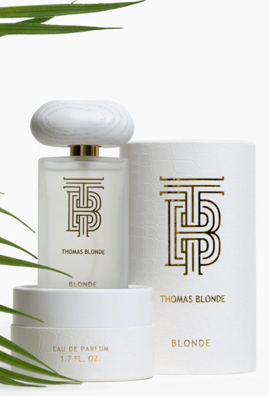 Bottle of Thomas Blonde Eau De Parfum in a clear glass container with blonde liquid.