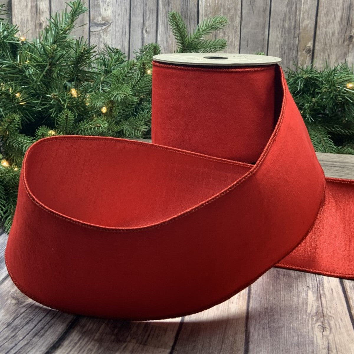 Red velvet fabric swatch measuring four inches by ten yards.
