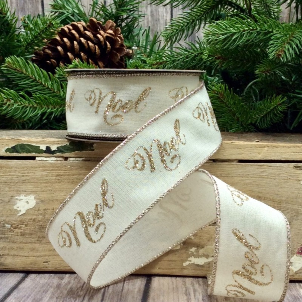 1.5 inch by 10 yard ivory cotton linen ribbon with platinum glitter Noel script and wired edges.