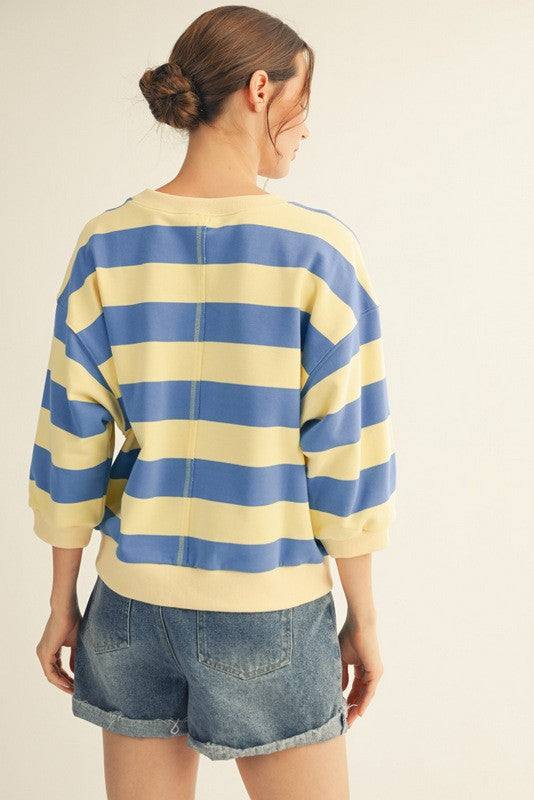 Roxanne casual top in bold stripe print with V-neckline; fabric is cotton and polyester blend.