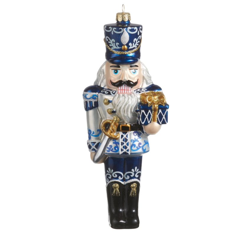 8.25-inch glass nutcracker ornament with blue and silver chinoiserie patterns holding a gift.