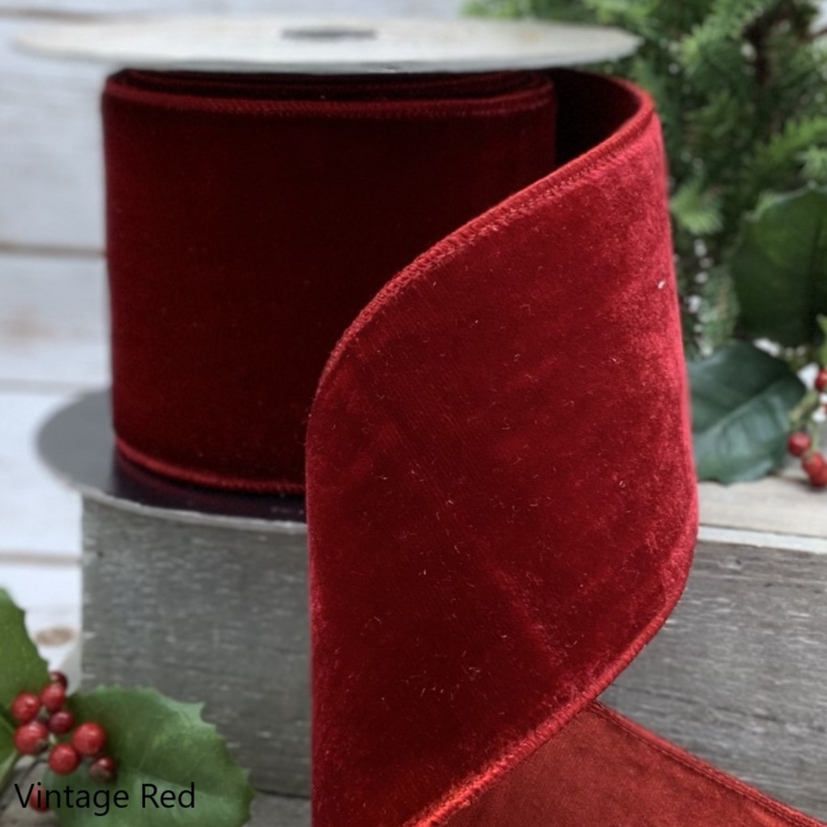 4 inch wide vintage red lush velvet ribbon with wired edges on a spool.
