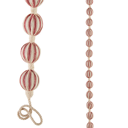 Five-foot hanging garland with ticking stripe ball ornaments made of plastic and cotton.