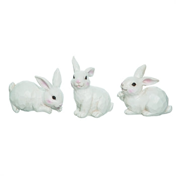 White sculpted bunny figurine with smooth finish measuring approximately four inches tall.