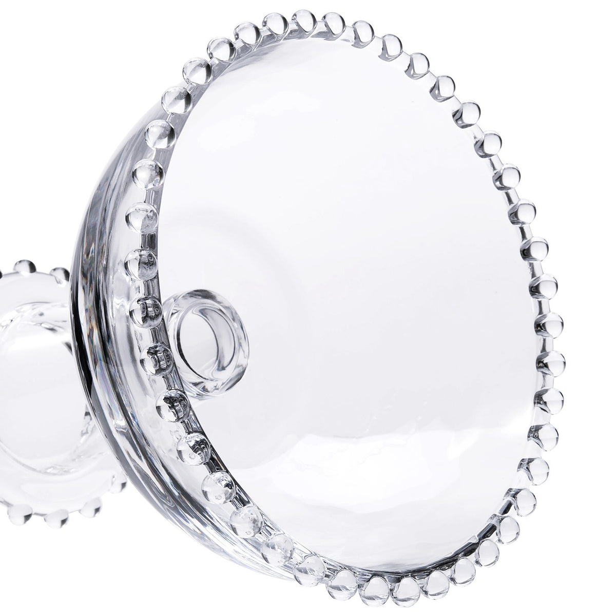 Close-up of a clear glass beaded dessert bowl with a decorative pearl-edged rim.