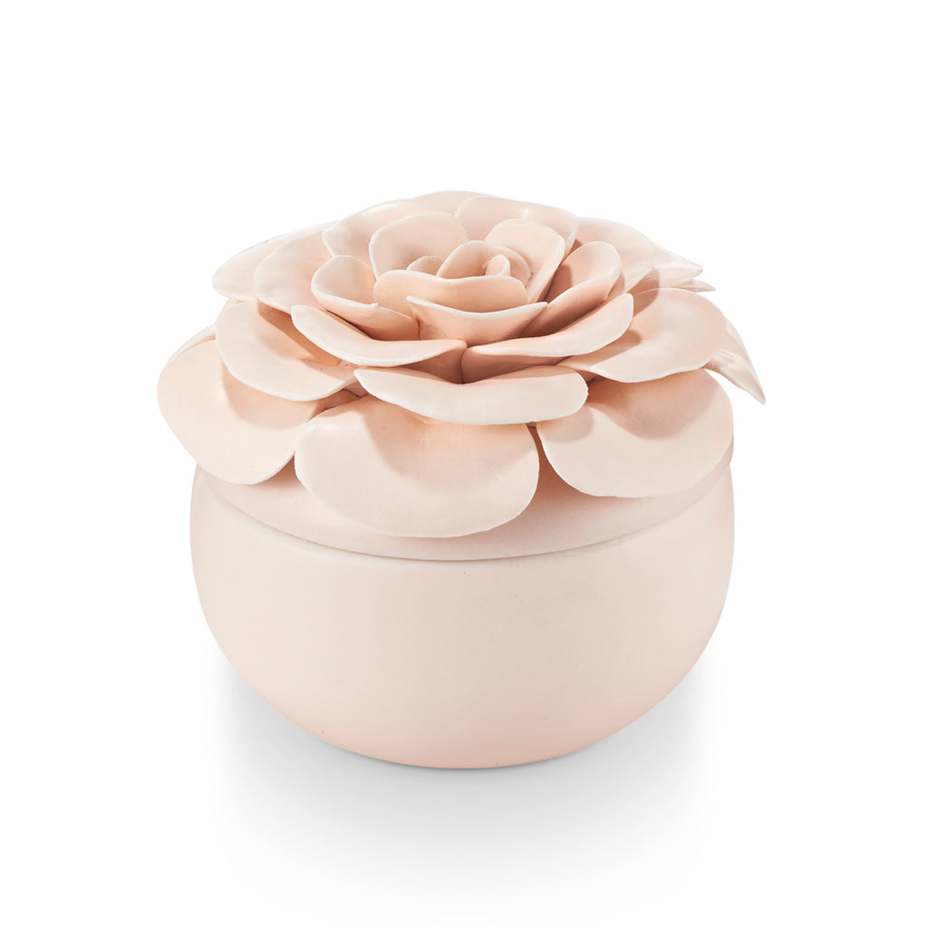 Ceramic flower candle with three wicks in a petal-shaped vessel.