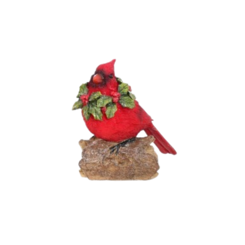Red resin cardinal figurine with a holly wreath collar perched on a rustic log.