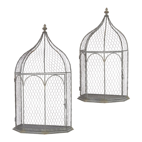 Set of two vintage-style grey metal wire bird cages with pointed tops and flat backs.