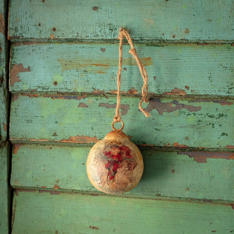 Four-inch metal ball ornament with subtle texture and shine in a round shape.