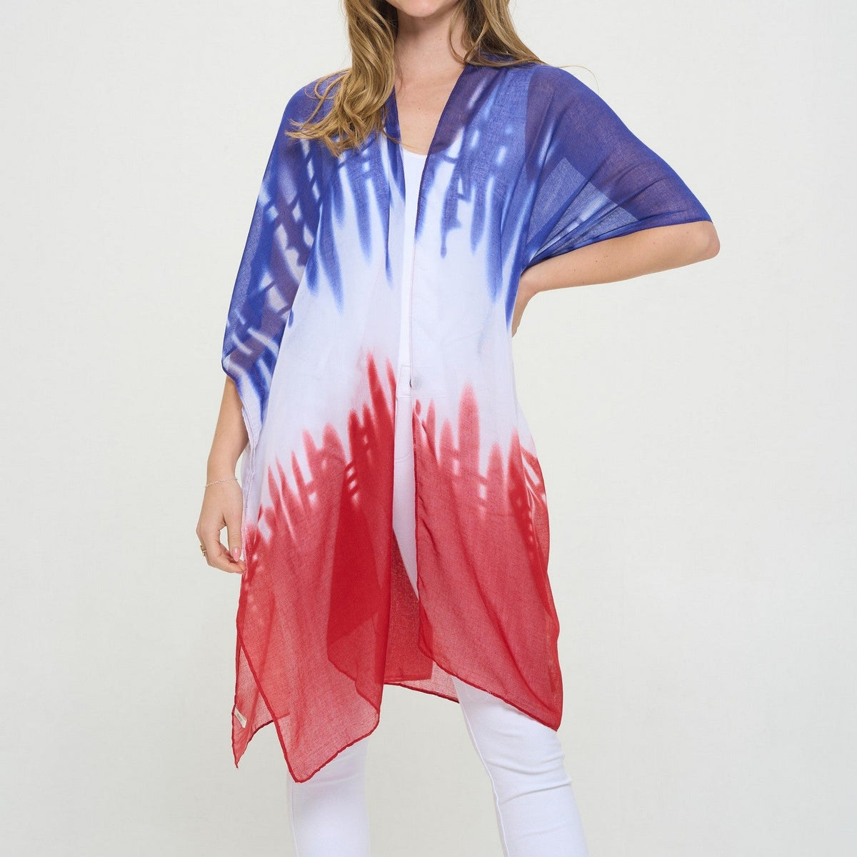 Woman wearing a Cooper American Flag Kimono with red, white, and blue tie-dye pattern.