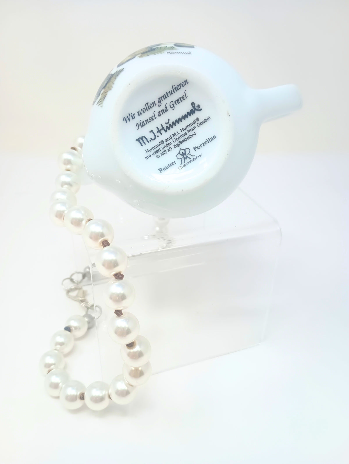 Porcelain teapot charm on a pearl necklace with M.I. Hummel artwork