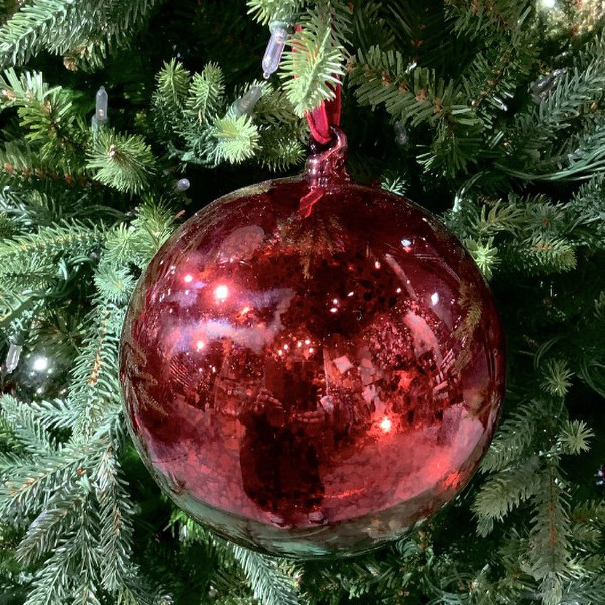 150mm hand-blown mercury glass ornament in vintage burgundy hanging on a green Christmas tree.