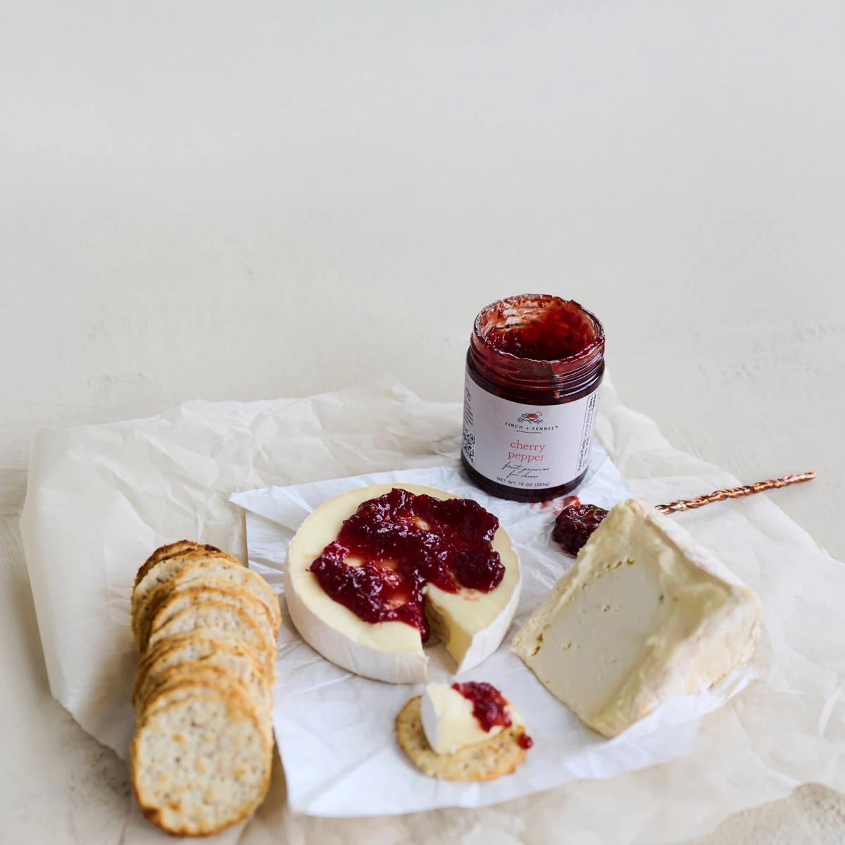 Jar of cherry pepper fruit preserves with a red lid