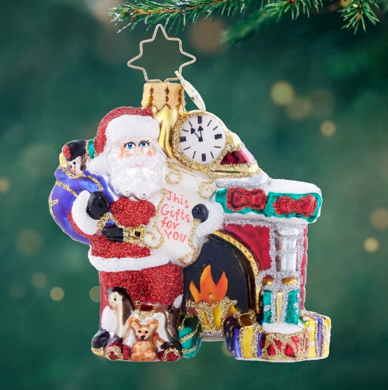 Nice List Santa Gem glass Christmas ornament featuring Santa by a fireplace with a gift list.