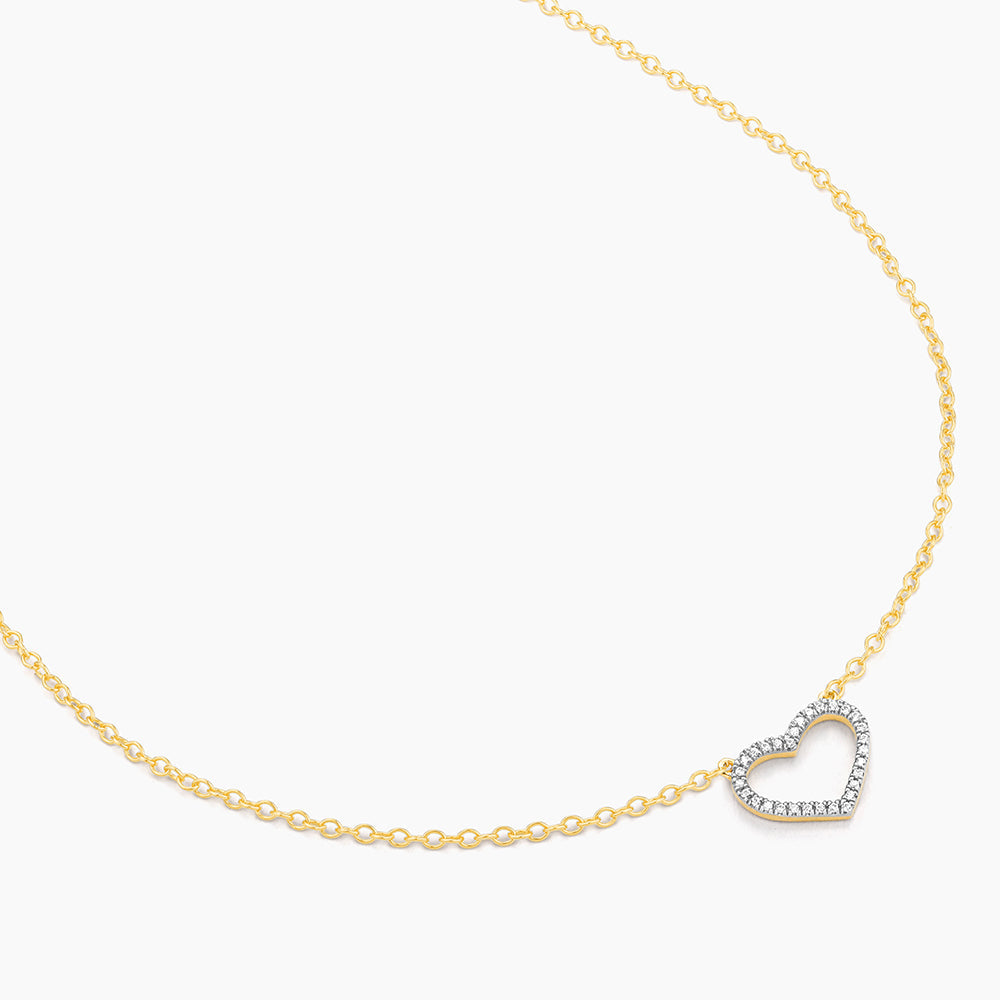 Sterling silver pendant necklace with gold-plated finish featuring a heart-shaped silhouette set with small diamonds.