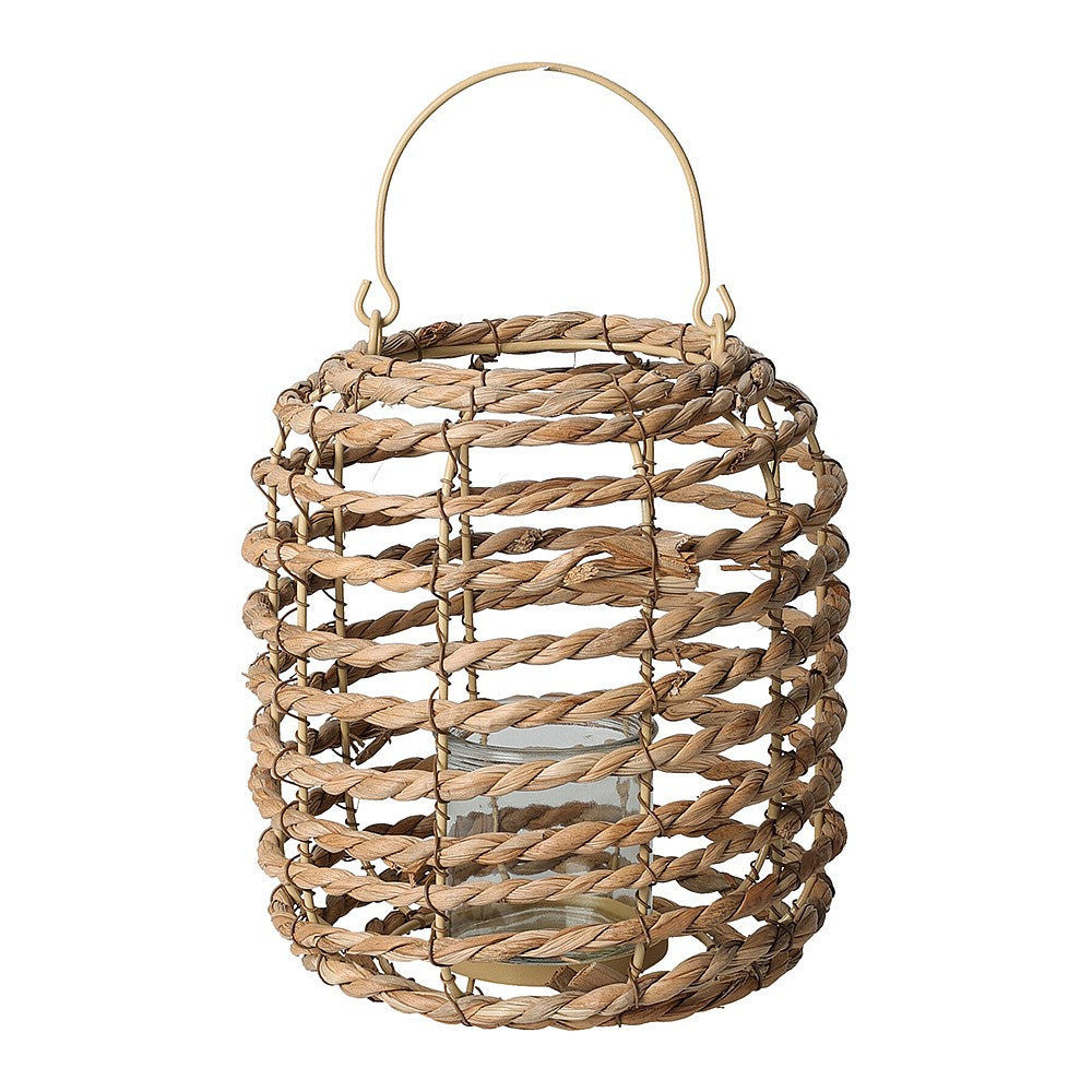 Natural cattail leaf lantern with metal frame holding a candle inside