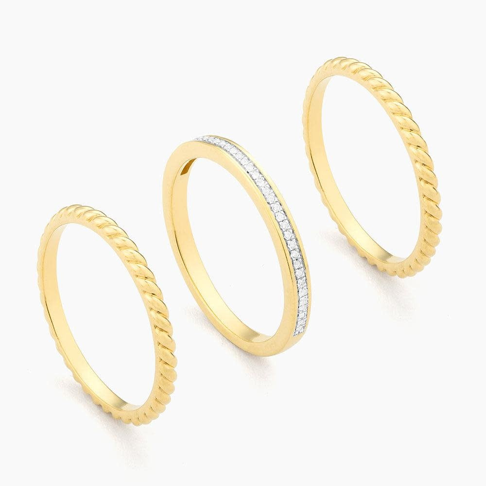 Side view of a Unite stackable ring in gold-plated sterling silver with a small diamond accent.