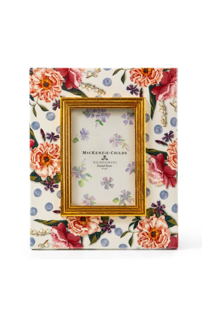 Blue enamel frame with wildflower pattern holding a photo