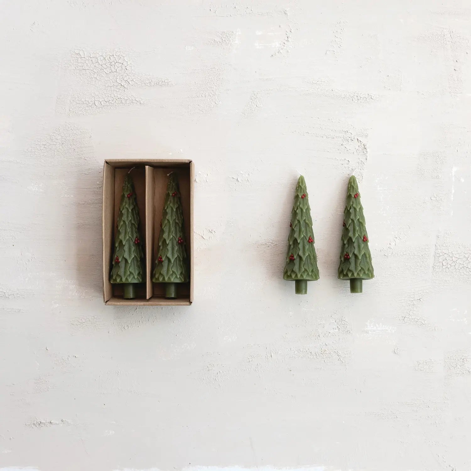 Unscented tree-shaped taper candle with a sculpted evergreen branch silhouette in natural wax.