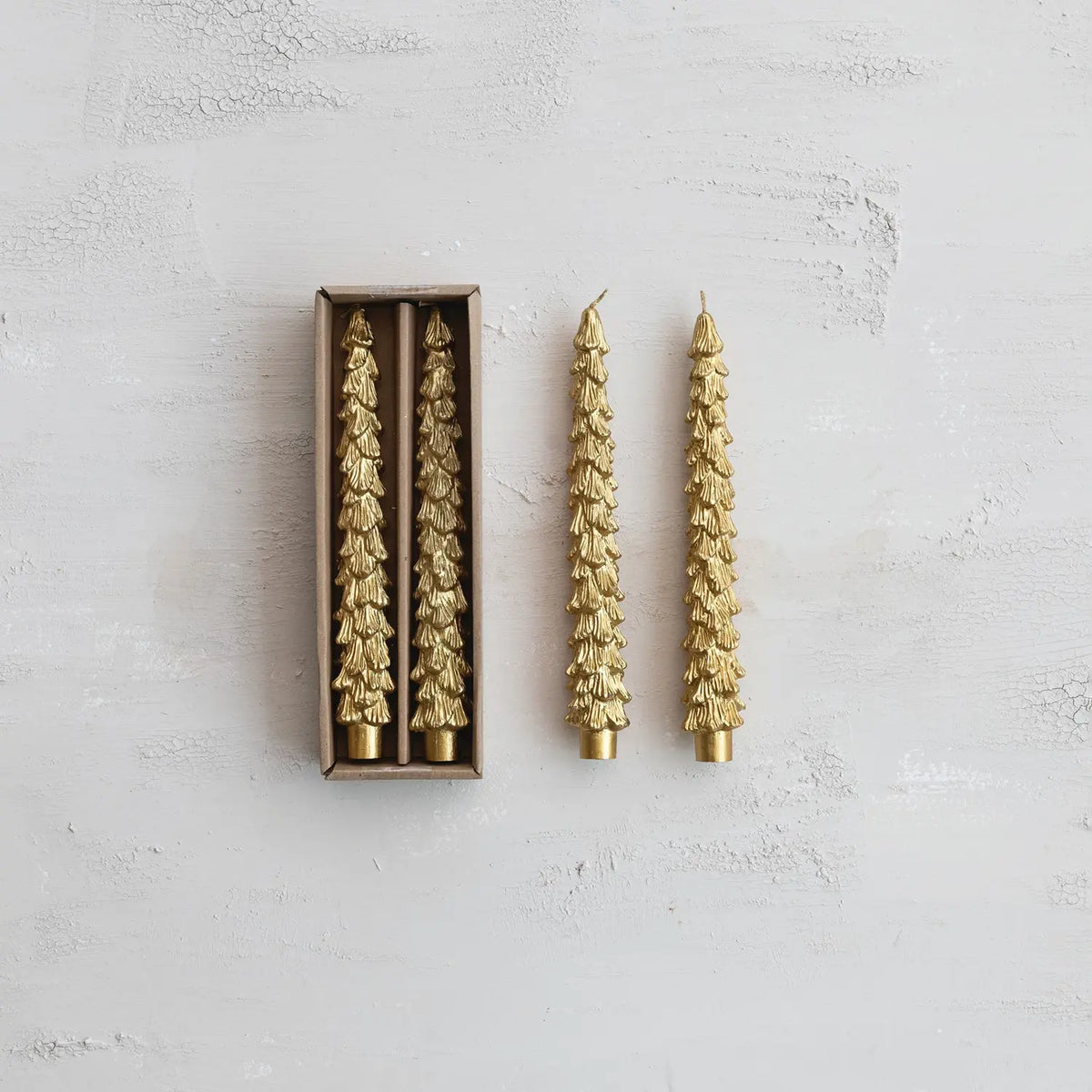 Set of gold unscented taper candles sculpted into a tree shape with tapered silhouette.