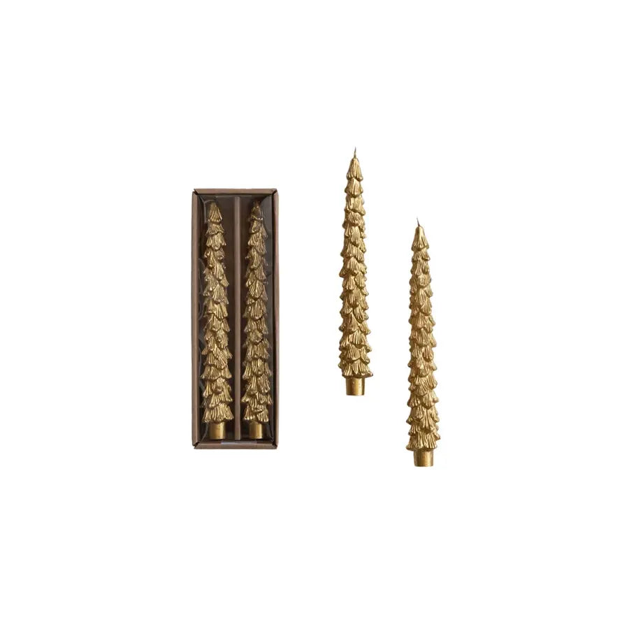 Set of three gold unscented taper candles with sculpted tree silhouettes.