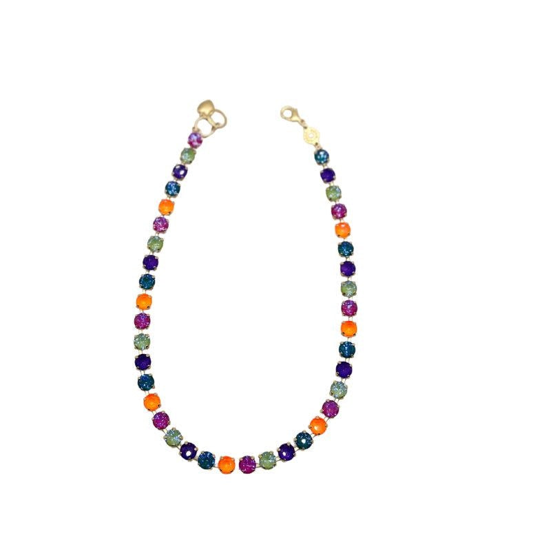 Gold RIO necklace featuring a circular pendant with an intricate geometric cutout pattern.