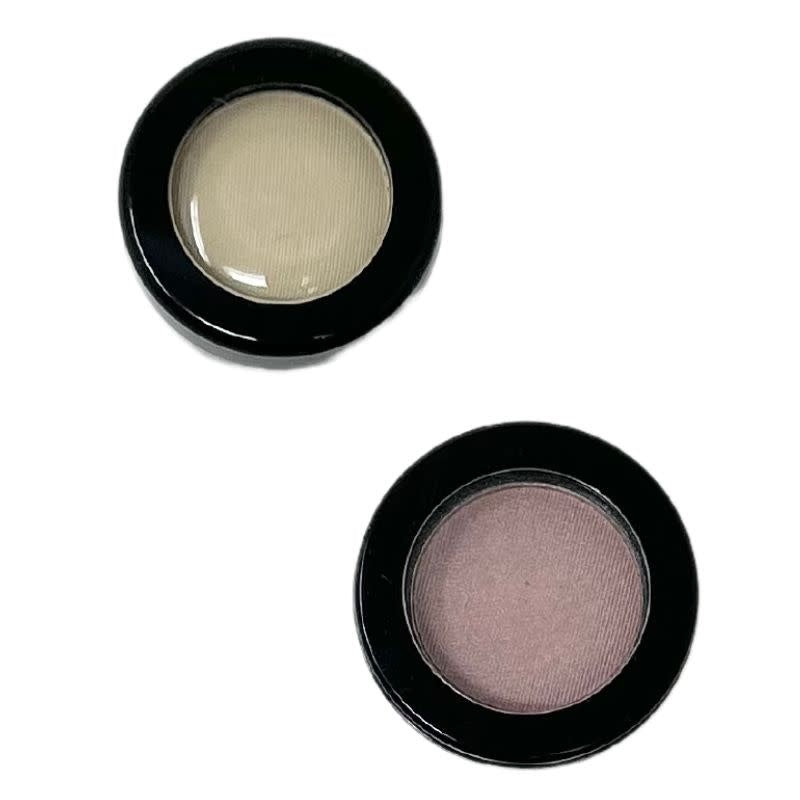 Two round eyeshadow compacts, one with a cream shade and one with a mauve shade.