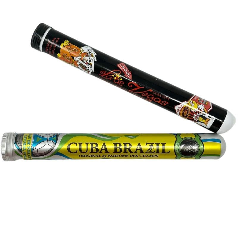 Two cigar-shaped cologne bottles, one black with Las Vegas graphics and one yellow with Brazil theme.