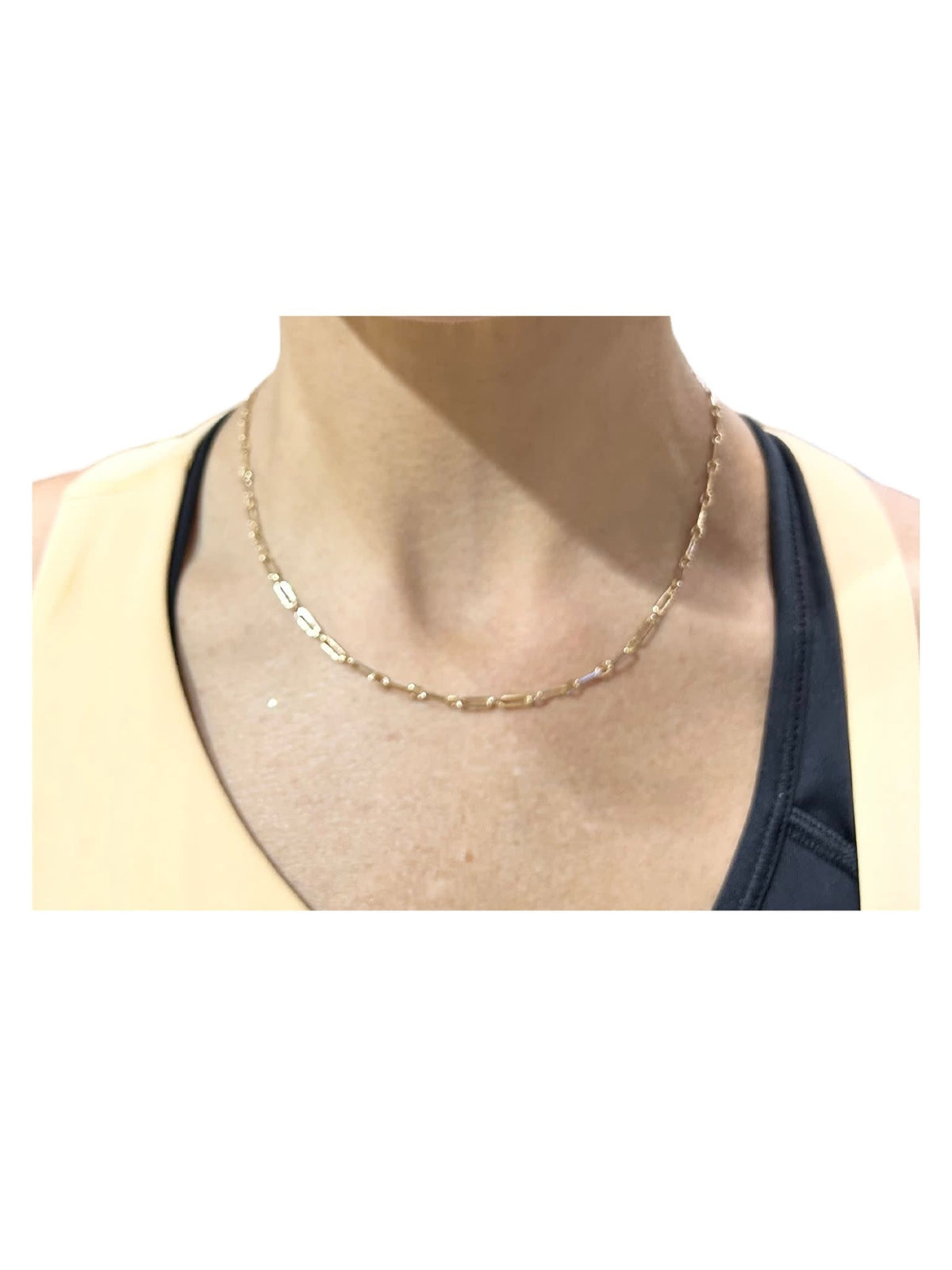Gold-colored necklace chain with a water-resistant finish displayed against a neutral background.
