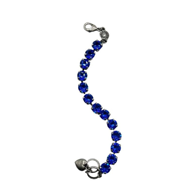 Classic Santorini bracelet featuring blue ombre stones, an amber tag with a crystal, and a Scotty dog heart charm.