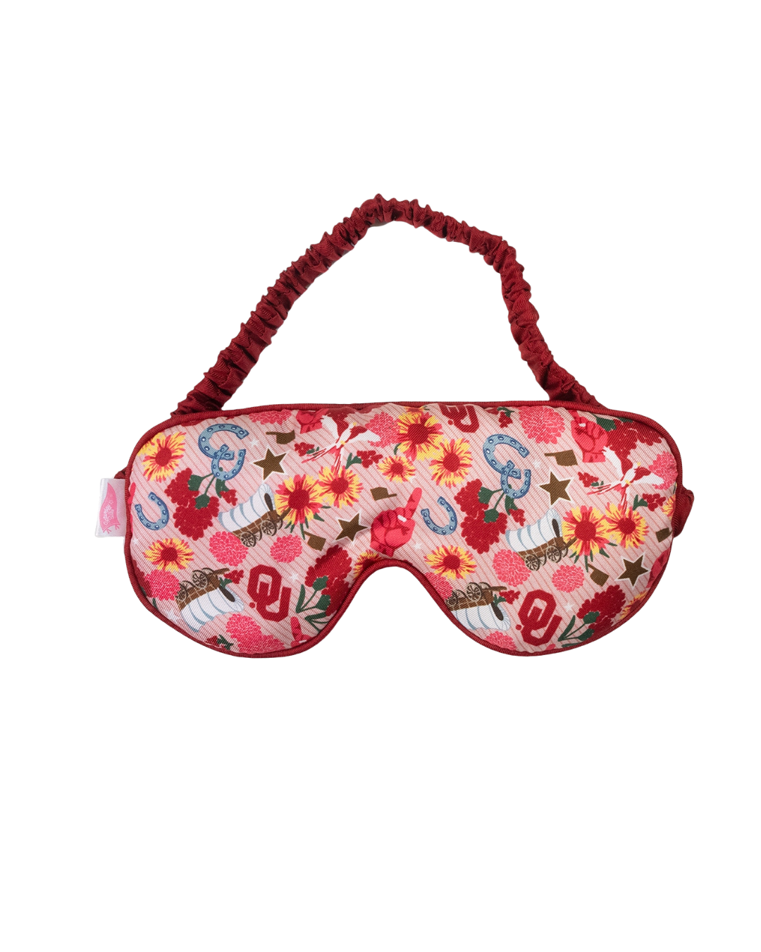 Red sleep mask with a floral pattern featuring Oklahoma Sooners logos, horseshoes, and wagons.