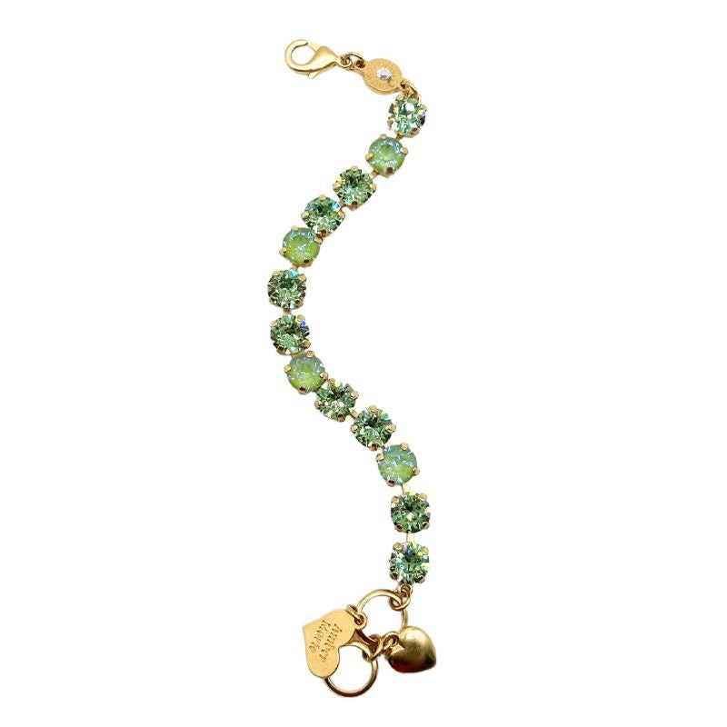 Green collage bracelet with amber tag, crystal accents, Scotty dog heart charm, and adjustable chain.