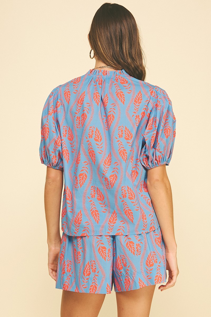 Ashley Botanical Print Blouse in sky blue cotton with vivid coral leaf block print.