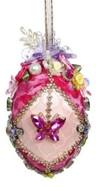 6-inch pink jewelled egg ornament with a butterfly gem, fabric flowers, and a ribbon hanger.