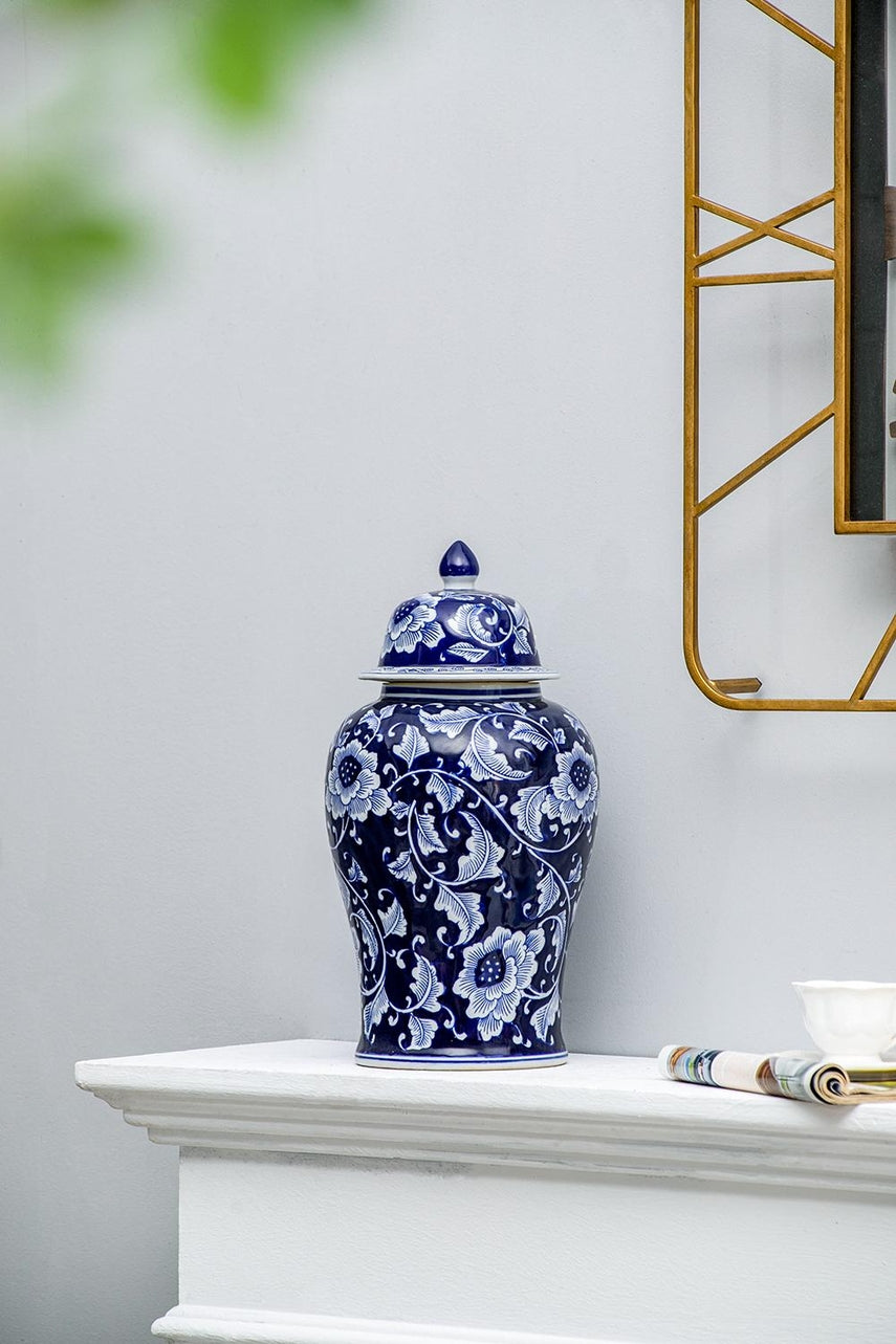 Aline Medium Ginger Jar in blue and white porcelain with floral patterns on a white mantle.