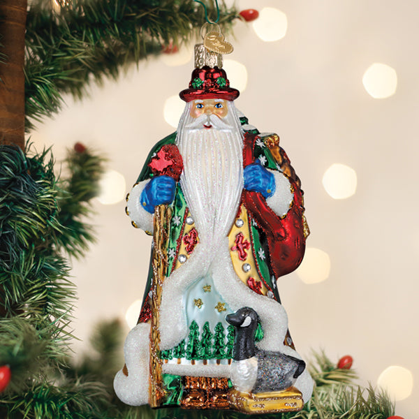 Red Canadian Santa ornament with maple leaf accents on a white background.