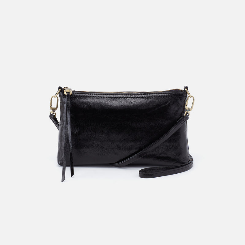 Darcy crossbody bag in solid leather with brushed antique brass hardware, zip closure, and convertible strap.