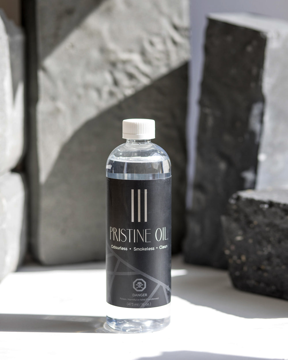 Pristine Oil candle in a clear glass bottle with white wax.