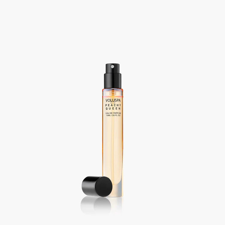 Voluspa Peachy Queen 10ml Eau De Parfum travel spray bottle with black cap removed.