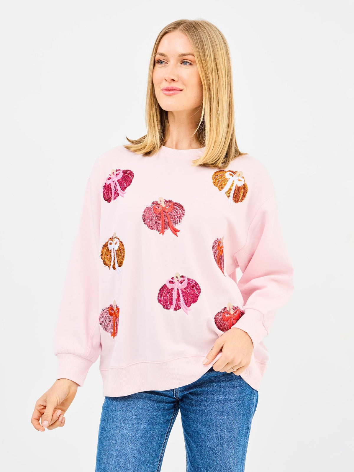 Relaxed fit Sarah sweatshirt in pumpkin hue with rayon-spandex blend featuring front bow embellishments.