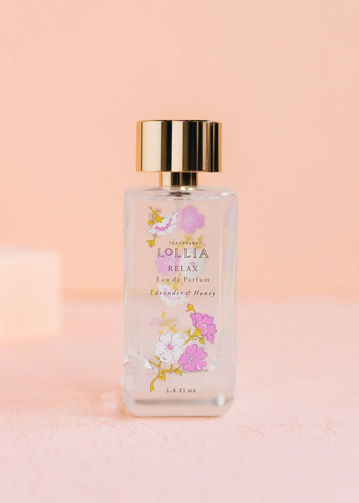 Relax Eau De Parfum bottle with curving glass shape, lavender and honey floral pattern on label