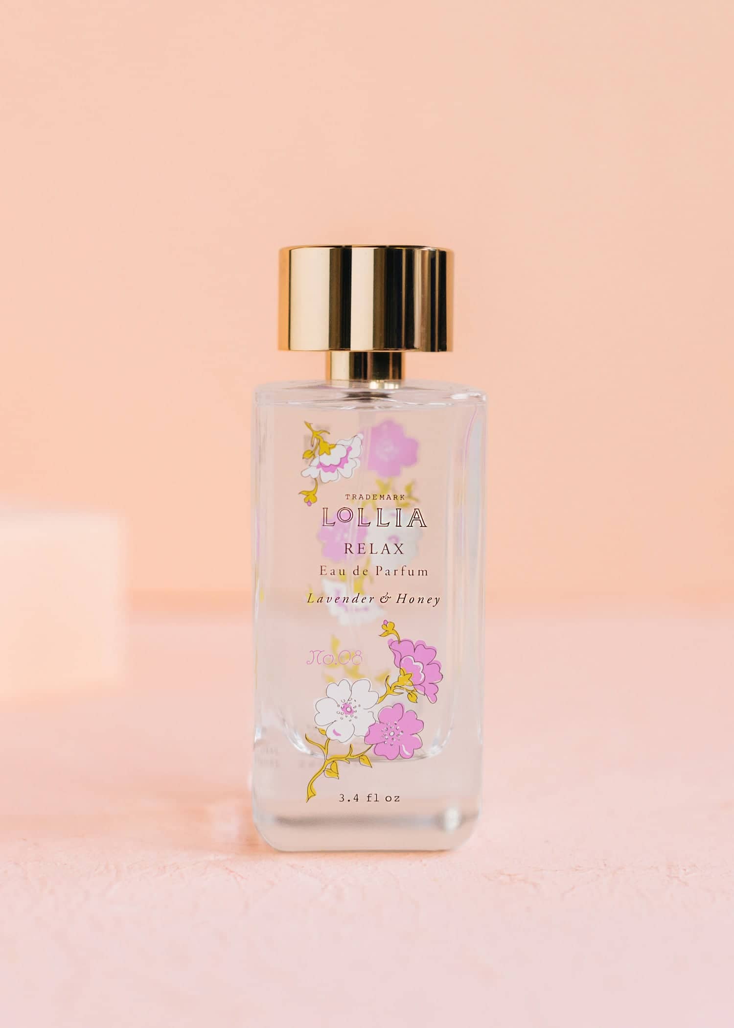 Relax Eau De Parfum bottle with curving glass shape, lavender and honey floral pattern on label