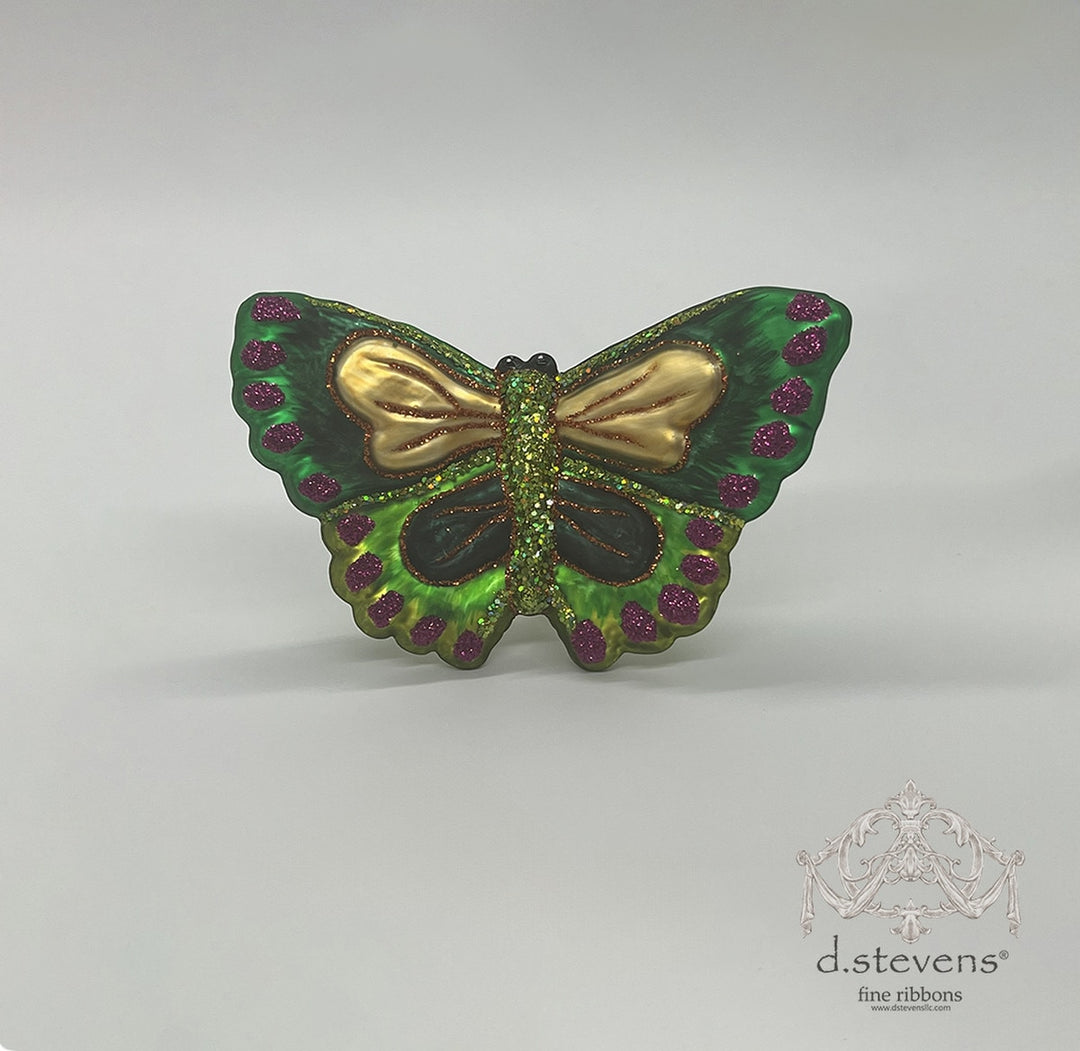 3.75-inch green glass butterfly ornament with gold wing accents and purple glitter spots.