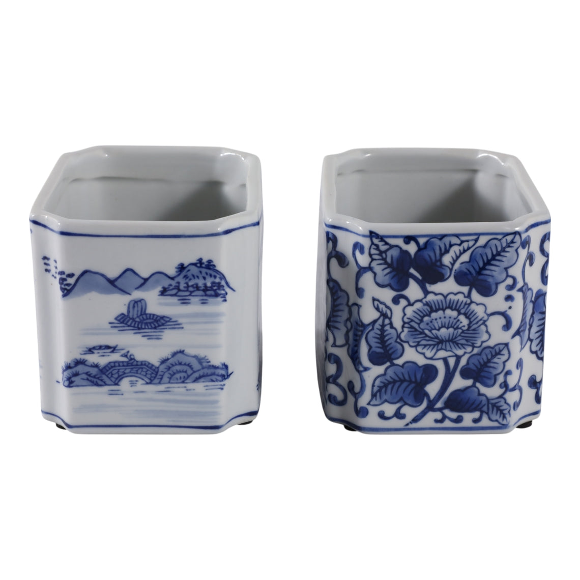 Two blue and white ceramic rectangle pencil cups with landscape and floral patterns.