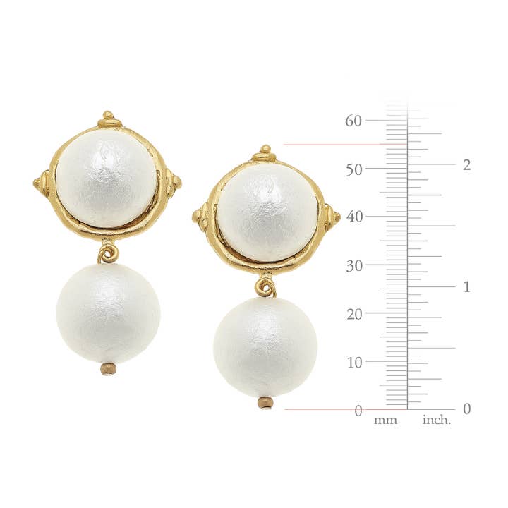 Gold clip earrings featuring a cotton pearl cabochon and a dangling cotton pearl drop.