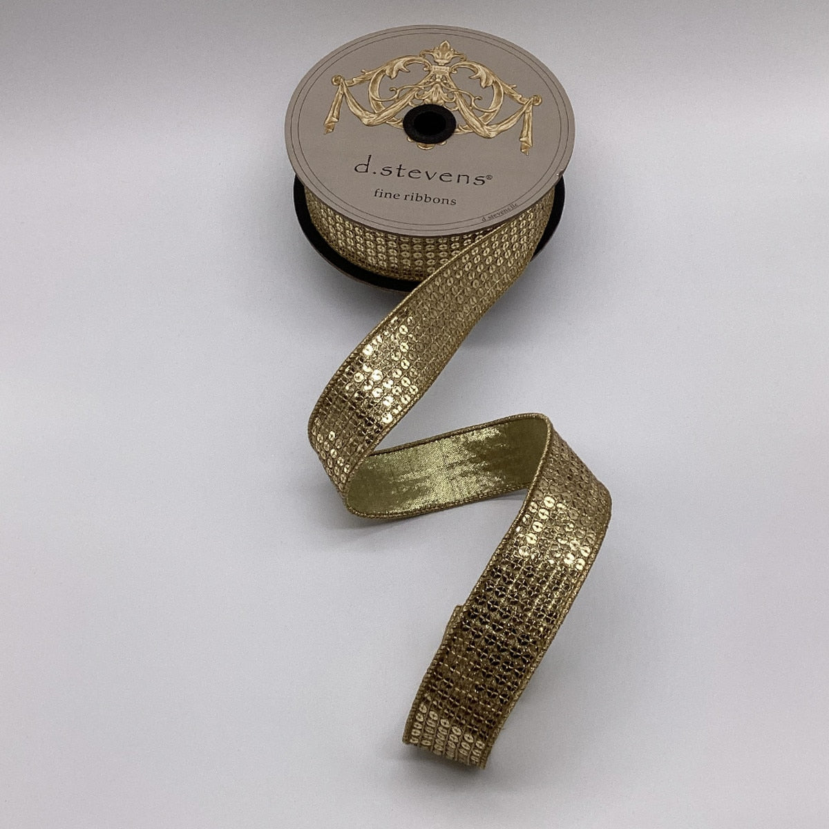 1.5 inch metallic gold flash sequin ribbon on a d.stevens spool against a white background.
